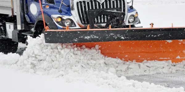 Machinery plowing snow